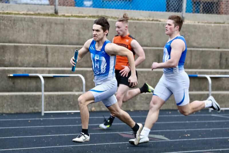 PHS' Keegan Fogarty takes the baton from teammate Drew Harp in Monday's Howard-Monier Invitational at Princeton. The Tigers won both the 4x100 and 4x200 relays.