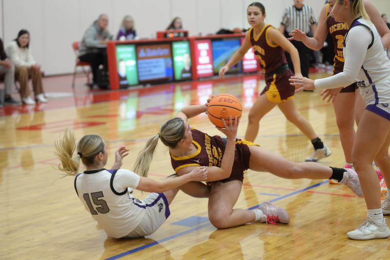 Dixon's Morgan Hargrave (15) and Richmond Burton's Daniella Mazzola (10) scarmble for a loose ball at the Oregon Girls Basketball Tip-Off Tournament on Wednesday, Nov. 20, 2024 at the Blackhawk Center in Oregon.