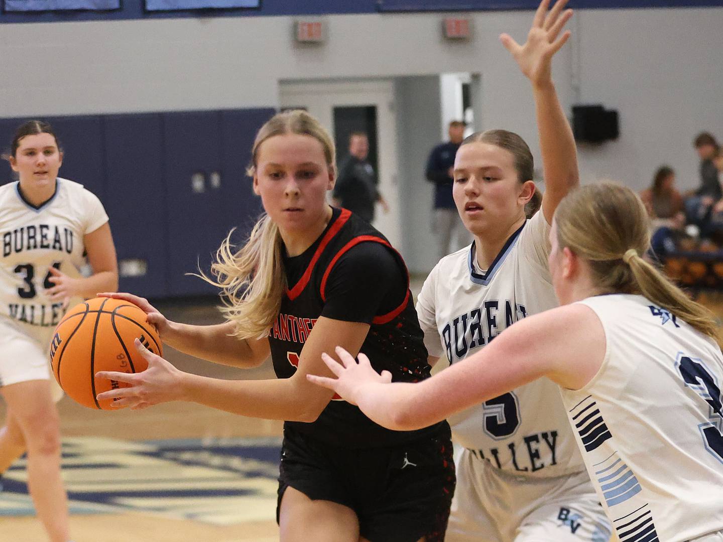 Erie-Prophetstown's Laruen Punke, works her way inside the lane as Bureau Valley defenders Emily Wright and Brooke Halms, defend during the Thanksgiving Tournament on Wednesday, Nov. 19, 2025 at Bureau Valley High School.