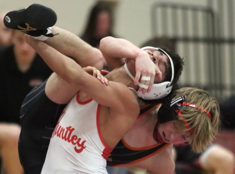 Huntley’s Julian Gutierrez, front, battles Crystal Lake Central’s Dylan Ramsey at 126 pounds in varsity wrestling on Friday, Dec. 13, 2024 at Huntley High School in Huntley.