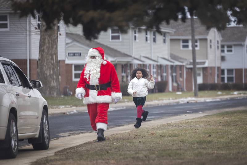 A youngster chases down the big guy himself Monday, Dec. 23, 2024, during a stop for Operation Santa in Rock Falls.