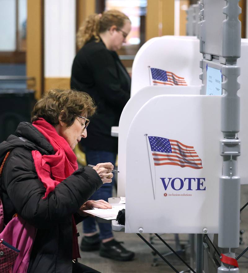 Catherine Raymond, (front) from Delkalb, casts her ballot Tuesday, April 1, 2025, in the polling place at the Westminster Presbyterian Church in DeKalb.