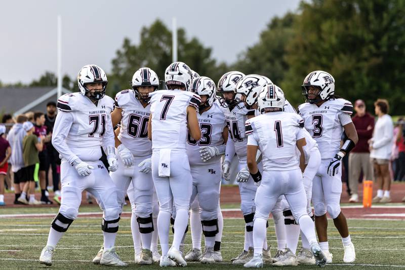 Plainfield North’s offensive players plot their next play during a varsity football game at Lockport Township High School East Campus on Aug. 29, 2025.