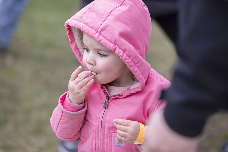 Maeleen Wolfe, 2, pops a piece of candy Saturday, March 30, 2024 in Polo.