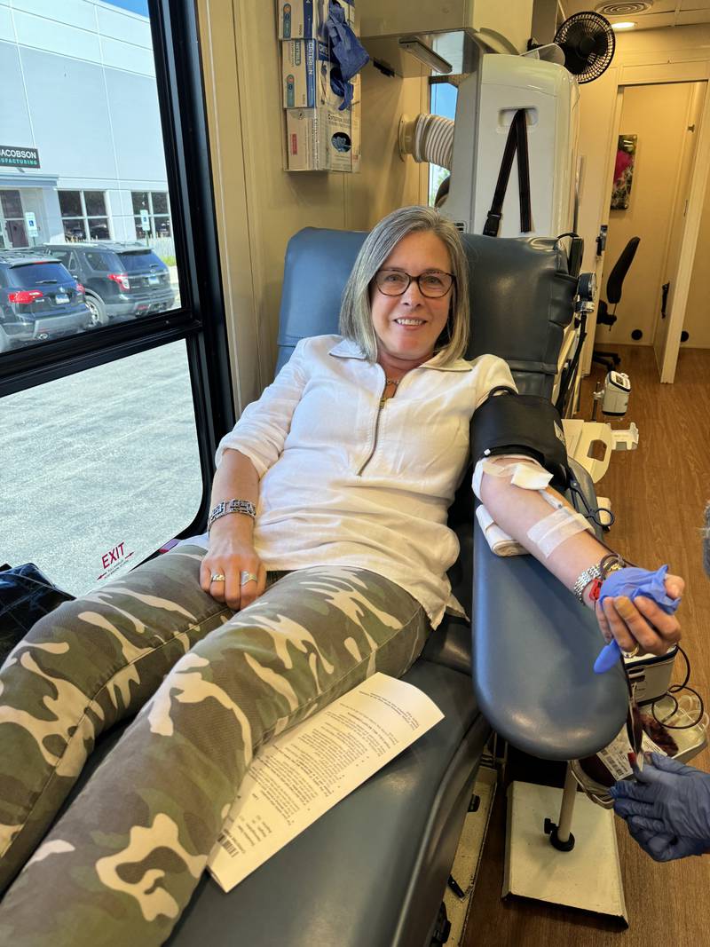 Chris Fisher, Brand and Cause Marketing Manager at Northern Illinois Food Bank, gave blood at a 'Double Hero Blood Drive' with Vitalant truck at the Food Bank's Lake Forest Center.