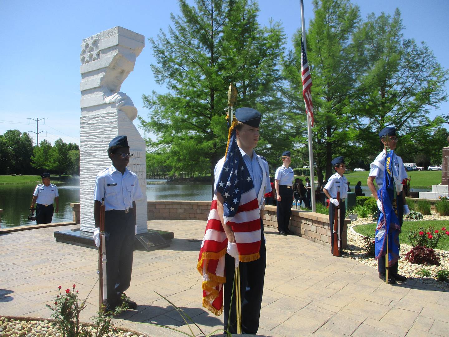 Cadet Squadron Commander James Giertuga (front center), Cadet AIC Jehmere Morris (left) and other members of the Civil Air Patrol Lewis Composit Squadron stand at attention during the Memorial Day service at Settlers' Park in Plainfield. May 25, 2026