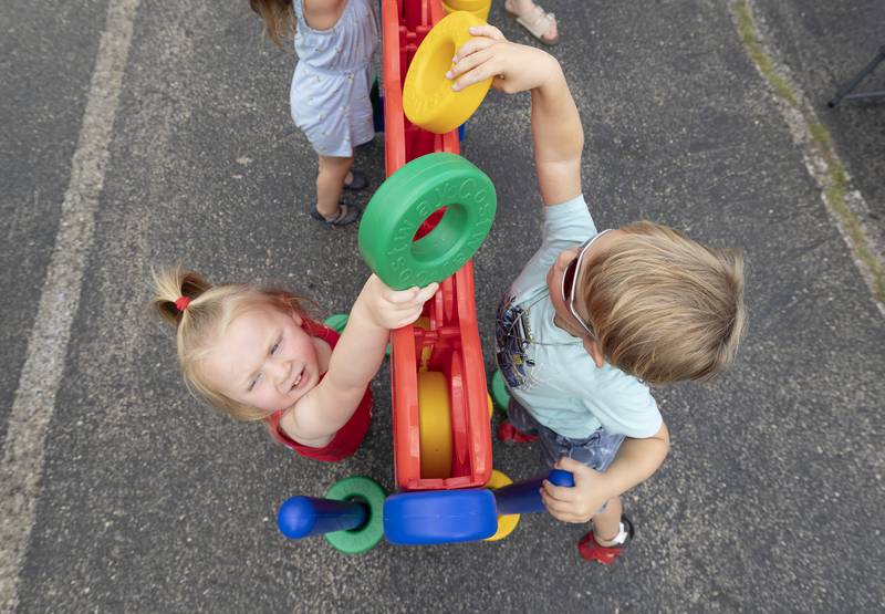 Brooklyn Clark (left), 3, reaches up to play a game Friday, June 30, 2023 during Petunia Fest’s Family Fun Night in Dixon. The annual Family Fun Night near the old Lee County Courthouse kicked off Petunia Fest with an ice cream social, games for the kids, a touch-a-truck and music by the Dixon Municipal Band.