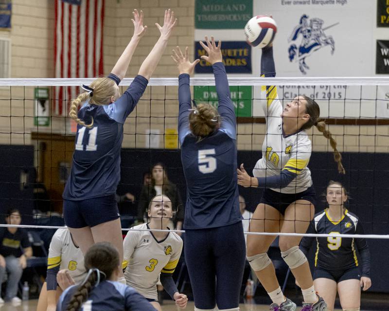 Kailana Thompson of Yorkville Christian attempts to spike the ball past two Cissna Park athletes during the Class 1A Sectional girls volleyball tournament at Bader Gym on November 5, 2024.