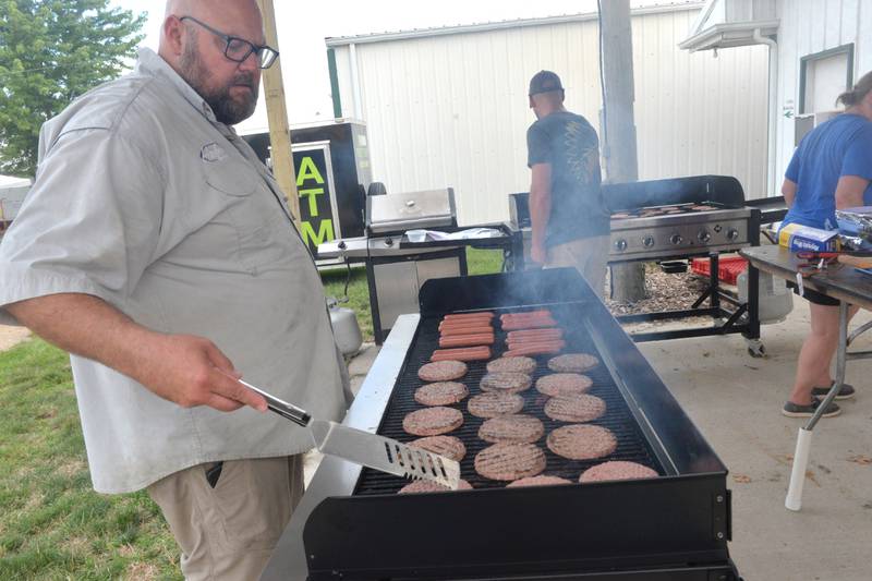 Matt Huber of Lee was grilling hamburgers and hot dogs at the Lee County 4-H Fair on Thursday despite temperatures in the mid 90s. He was volunteeering his time for the Willow Creek Winners 4-H Club.
