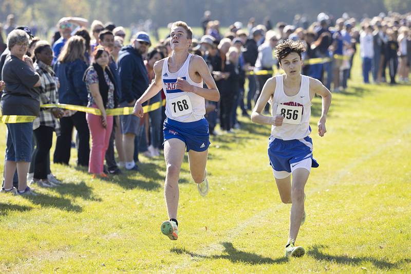 John Daffenberg (left) of Marmion takes 7th place just ahead of Jaden Frederick of Glenbard South Saturday, Oct. 22, 2022 class 2A cross country regional in Sterling.