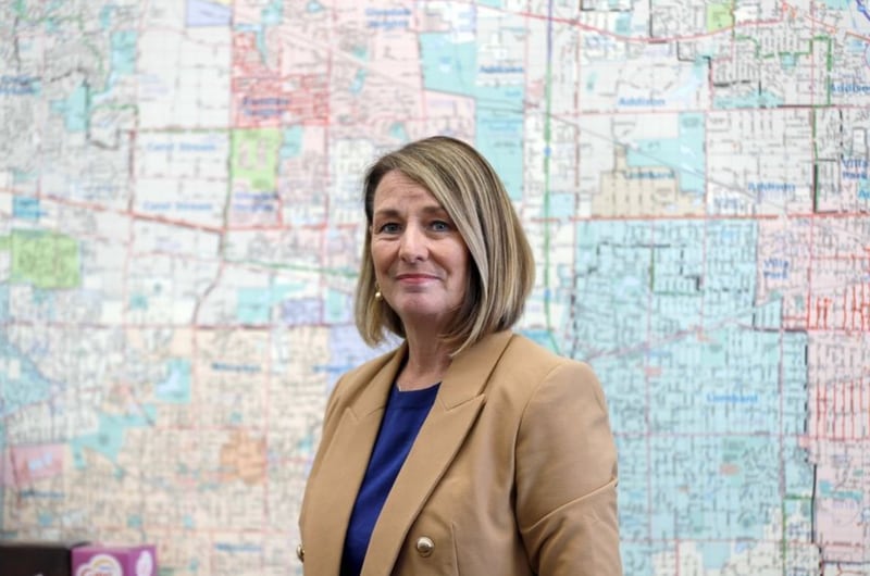 State Rep. Deb Conroy stands before a map of DuPage County in her constituent office Wednesday in Villa Park. The Democrat is poised to become the first woman to lead the DuPage County Board as chair