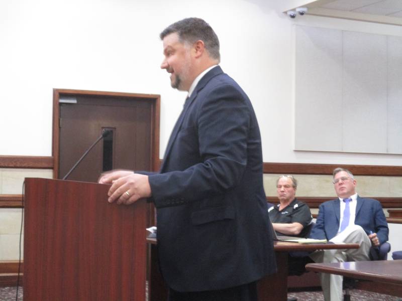 Kendall County State's Attorney Civil Division Chief Jim Webb delivers arguments seeking dismissal of a lawsuit by Todd Milliron of Yorkville against the County Board on May 2, 2023. Milliron and his attorney Ed Mullen of Chicago are seen in the background.