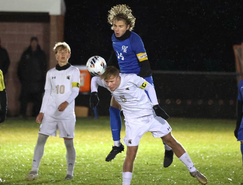 Sycamore's Aiden Sears heads the ball away from Burlington Central’s Noah Rosborough Tuesday, Oct. 21, 2025, during their IHSA Class 2A regional semifinal match at Burlington Central High School.