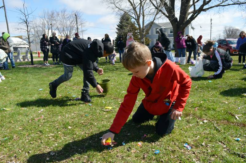 Brantley Butler, 9, of Forreston, grabs handfuls of candy and plastic eggs, stuffing them into his sweatshirt pocket. Forreston's annual Easter egg hunt took place in Memorial Park on April 16.