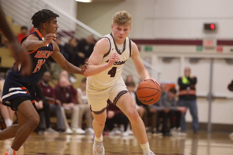 Lockport’s Adam Labuda makes a move at the top of the key against Oswego.