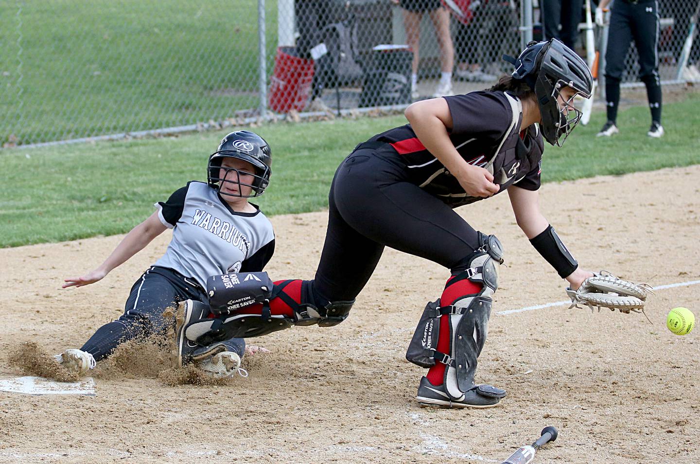 Woodland/Flanagan-Cornell baserunner Isabel Gwaltney slides in to score the game's first run as Henry-Senachwine catcher Kaitlyn Anderson corals the throw home Monday, May 8, 2023, in Henry.