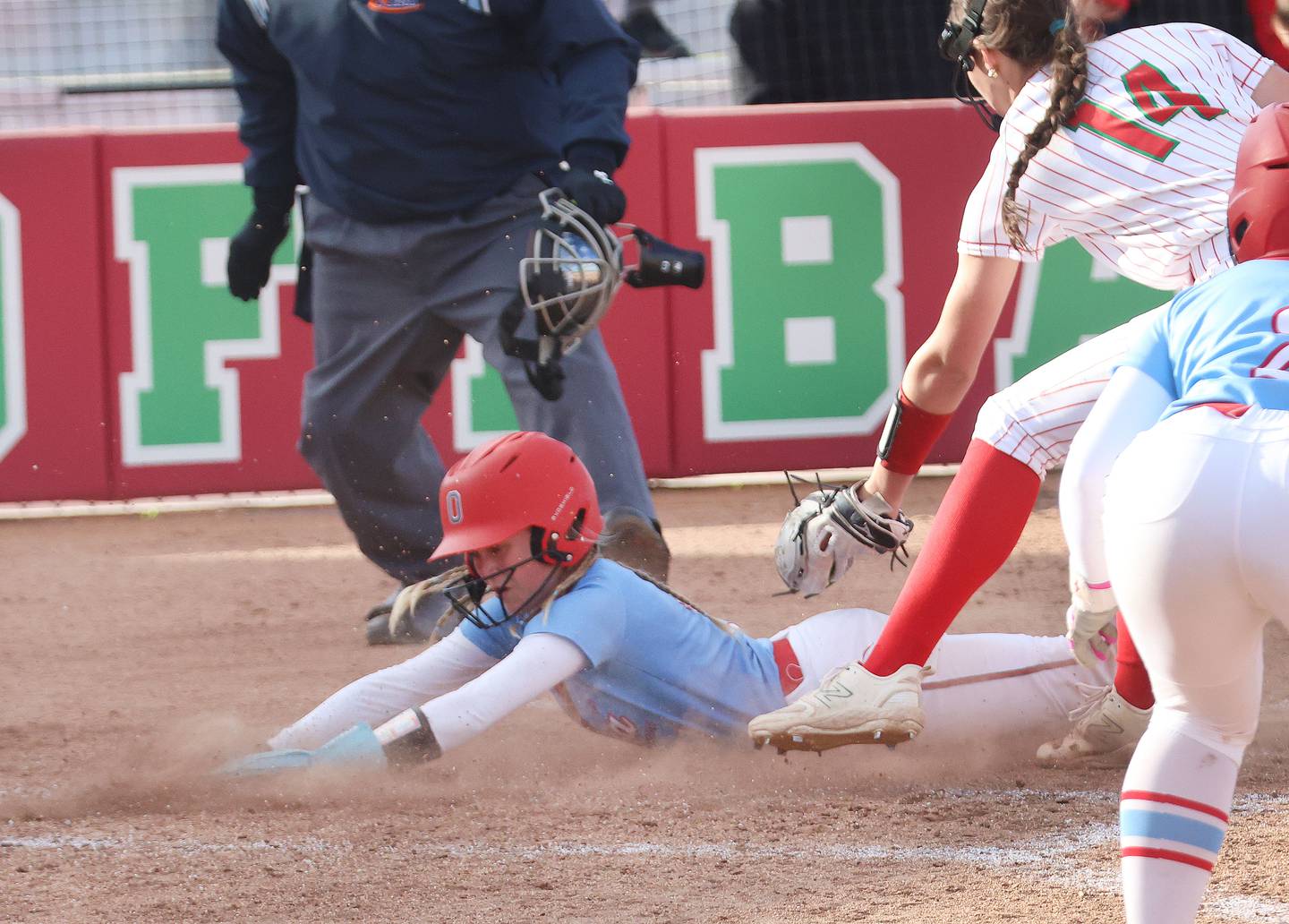 Ottawa's Rylee Harsted slides in safely to home on a passed ball as L-P's Brianna Ruppert misses the tag on Wednesday, April 29, 2026 at the L-P Athletic Complex in La Salle.
