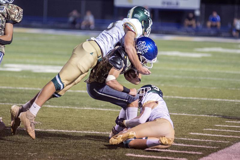 Newman’s Nolan Britt gets taken down by a pair of St. Bede defenders Friday, Sept. 16, 2022.