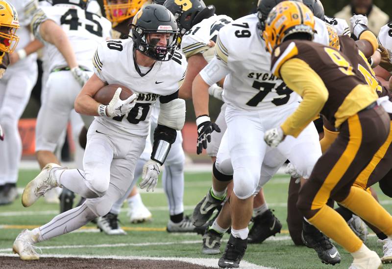 Sycamore's Zack Crawford looks to get by Carmel's Dev'ion Reynolds during their Class 5A second round playoff game Saturday, Nov. 5, 2022, at Carmel Catholic High School in Mundelein.