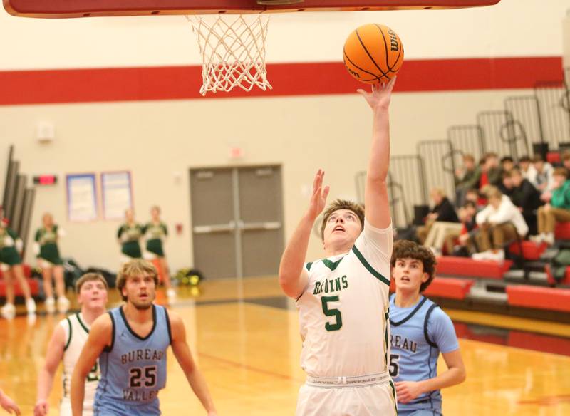 St. Bede's Halden Hueneburg runs in all alone to score over Bureau Valley's Landon Hulsing and Logan Philhower during the 50th annual Colmone Classic on Thursday, Dec. 12, 2024 at Hall High School.