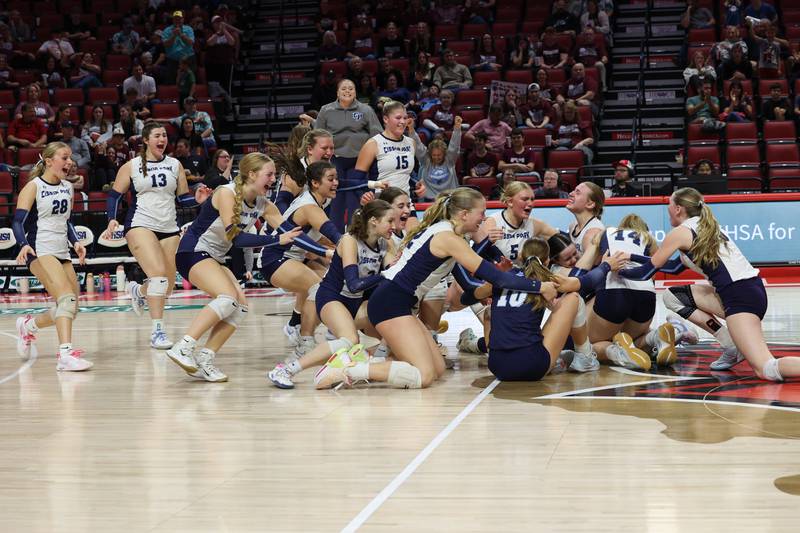 Cissna Park players rush the floor as the Timberwolves secured a victory in two sets, 25-11, 25-14, over Stockton in the IHSA Class 1A State championship on Saturday, Nov. 15, 2025.