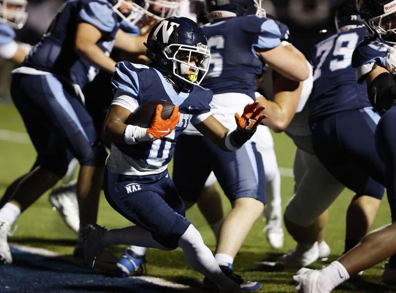 Nazareth's Edward McCklain Jr. (0) runs with the ball during the varsity football game between Joliet Catholic and Nazareth academies on Friday, Sep. 27, 2024 in La Grange Park.