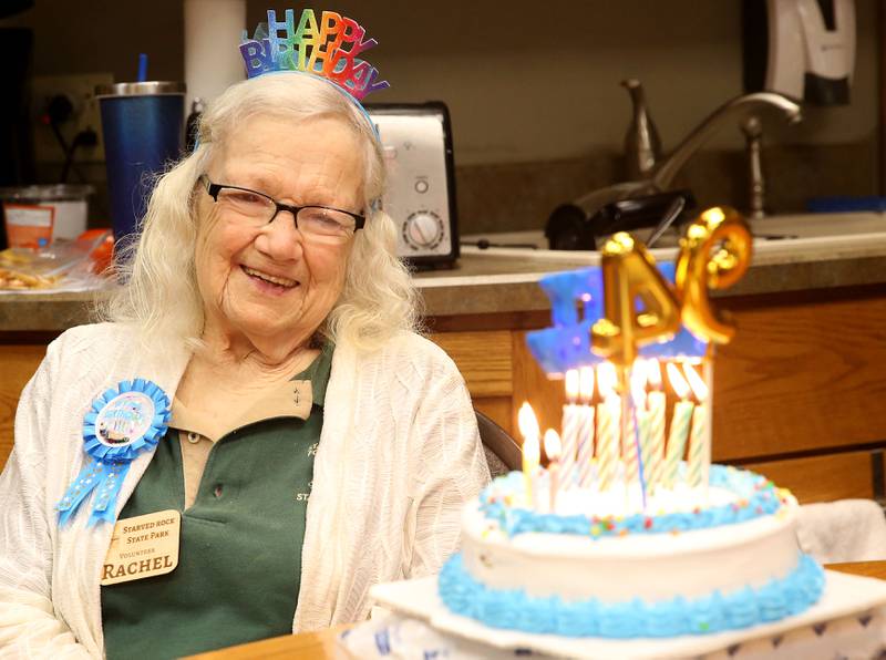 Rachel Mershon 94 of Granville, smiles while blowing out the candles on her birthday cake on Monday, Sept. 22, 2025 inside the Starved Rock Visitors Center. Merschon, A former junior high teacher in Spring Valley, volunteers in the bookstore at the Starved Rock Visitors Center. Merschon drives to the Visitors Center every Monday to volunteer at the park.