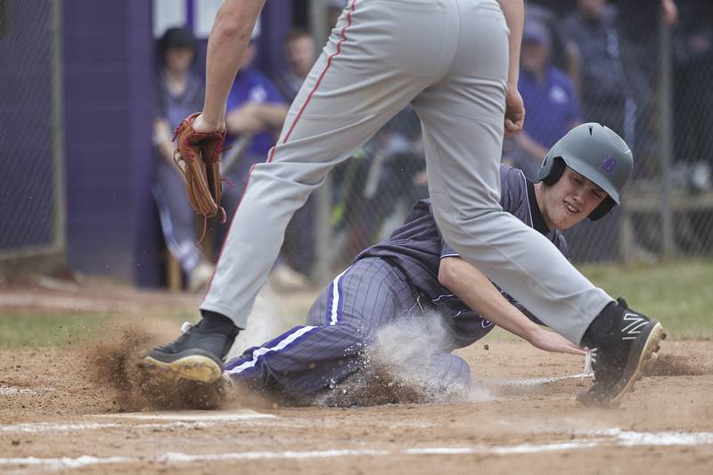 Dixon’s Bryce Feit steal home against Rockford Jefferson Wednesday, March 13, 2024 to open the Dukes’ baseball season.