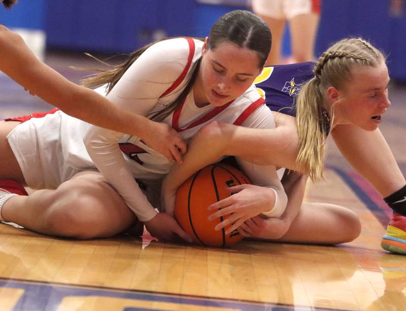 Huntley’s Maya Mangan, center, fights for the ball against Hononegah in girls basketball at Dundee-Crown High School in Carpentersville on Tuesday, November 25, 2025.