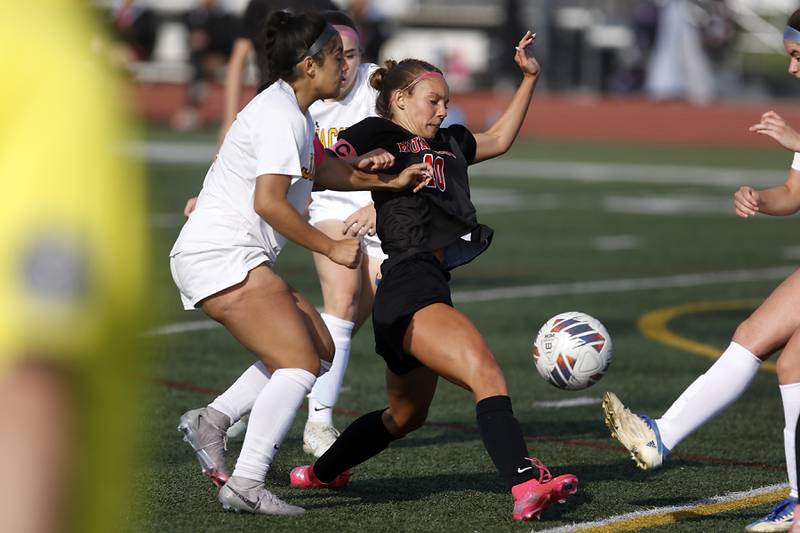 Huntley's Maddie Cummings tries to kicks the ball between Jacobs' Sam Diaz (left) and Brenna Flaskamp (right) during the IHSA Class 3A Huntley Girls Soccer Regional championship match on Friday, May 23, 2025, at Huntley High School.