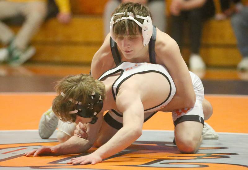 Sycamore's Carson West wrestles Washington's Symon Woods in the 106 weight class during the Class 2A Sectional championship on Saturday, Feb. 15, 2025 at Washington High School.