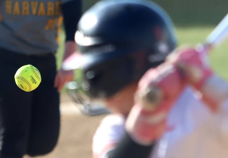 The ball sails in as Crystal Lake Central’s Ella Arana considers the offering from Harvard’s Kara Knop in varsity softball at Crystal Lake Central High School in Crystal Lake on Monday, May 19, 2025.