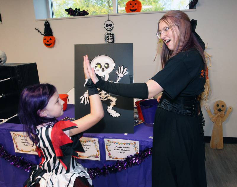 Carter Royeen, 8, of Lindenhurst gets a high-five from Chloe Stotz, 16, a volunteer in the National Honor Society from Grayslake North High School, after playing Pin the Smile on the Skeleton during Witchy Thrills & Chills at the Lindenhurst Park District Lippert Community Center on October 14th in Lindenhurst.
Photo by Candace H. Johnson for Shaw Local News Network