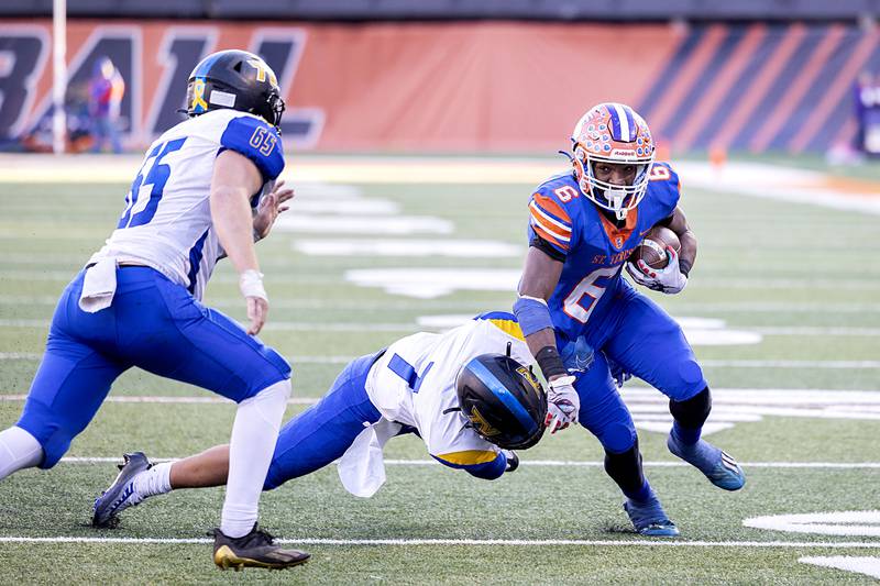 St. Teresa’s Elijah Wills fights for yards while being tackled by Tri-Valley’s Nicholas Traugott in the class 2A IHSA football state championship game Friday, Nov. 25, 2022.
