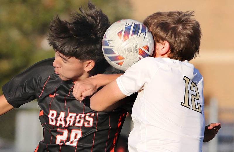 DeKalb's Diego Rivas (left) and Sycamore's Carter England try to head the ball during their game Tuesday, Oct. 4, 2022, at DeKalb High School.