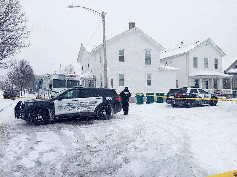 Joliet police vehicles block off the corner of Garnsey Avenue and Ward Street near a house where a 4-year-old boy and a 36-year-old woman were shot to death Sunday, Jan. 25, 2026.