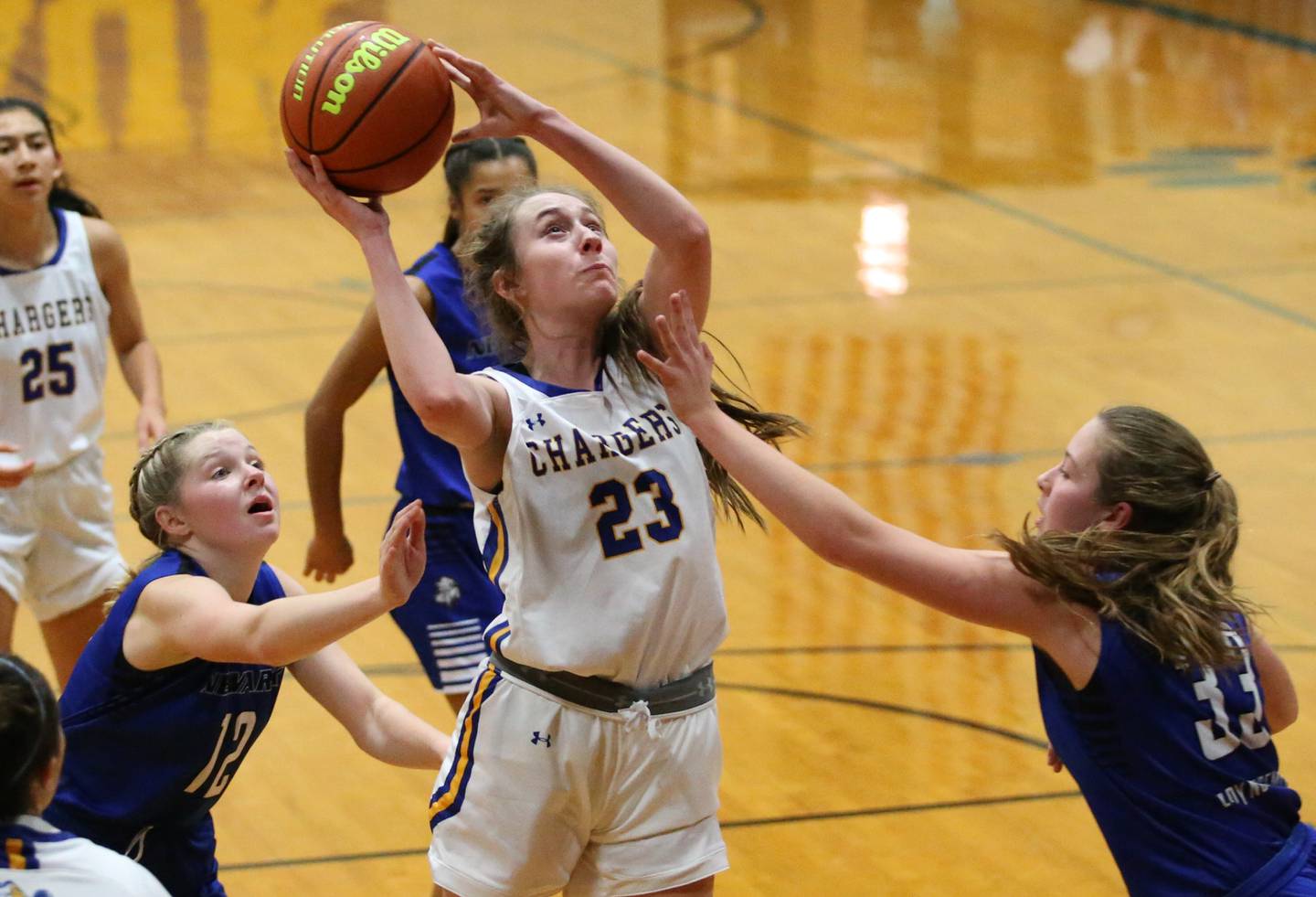 Aurora Central Catholic's Riley Cwinski (23) splits Newark defenders Tess Carlson (12) and teammate Peyton Wallin (33) in the Tim Humes Breakout Tournament on Friday, Nov. 18, 2022 in Somonauk.