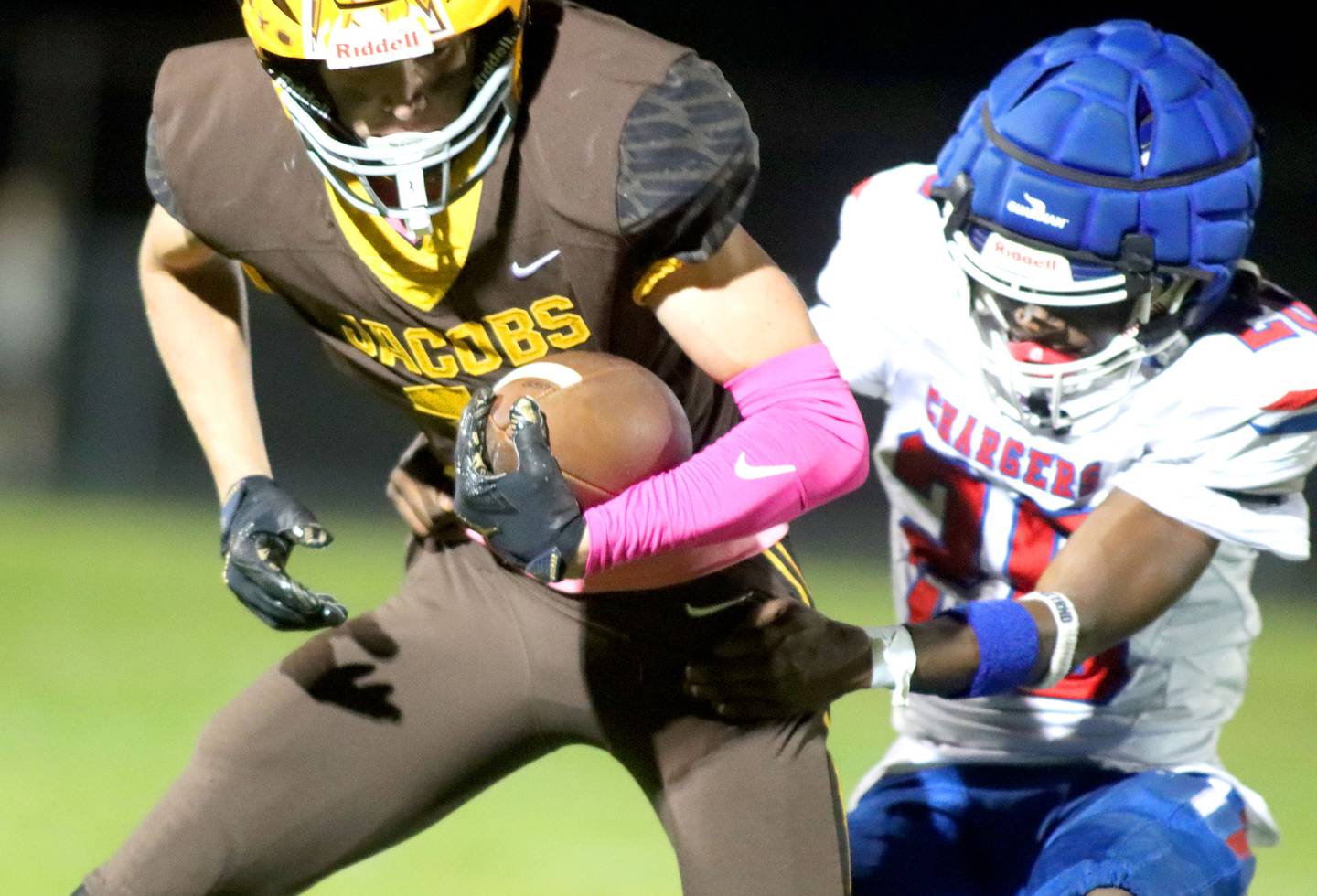 Jacobs’ Carson Goehring, left, gets past Dundee-Crown’s Ereyon Bailey in varsity football  at Jacobs High School in Algonquin on Friday, Oct. 10, 2025.