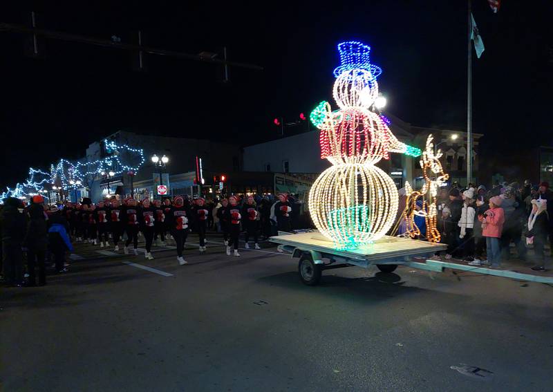 Ottawa High School cheerleaders follow a lighted snowman during the Festival of Lights parade Friday, Nov. 24, 2023, in Ottawa.