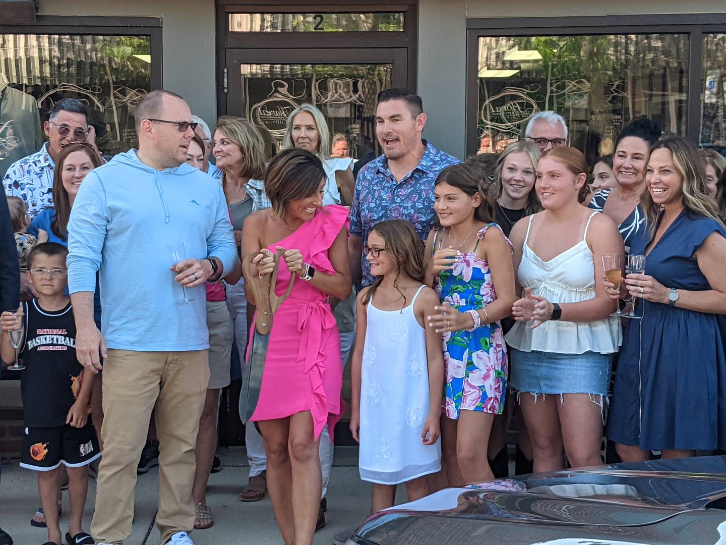 American-Male co-owner Gabby Plachetka cuts the ribbon at a June 20 ribbon-cutting ceremony for American-Male in downtown Oswego as Oswego Village President Ryan Kauffman, left, looks on.