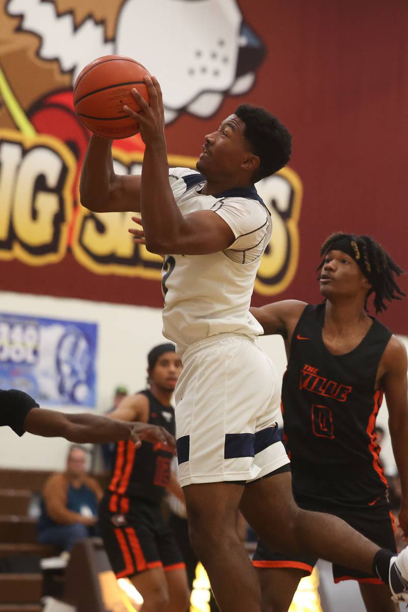 Lemont’s Miles Beachum goes in for the shot against Romeoville in the WJOL Thanksgiving Classic Championship in Joliet on Saturday.