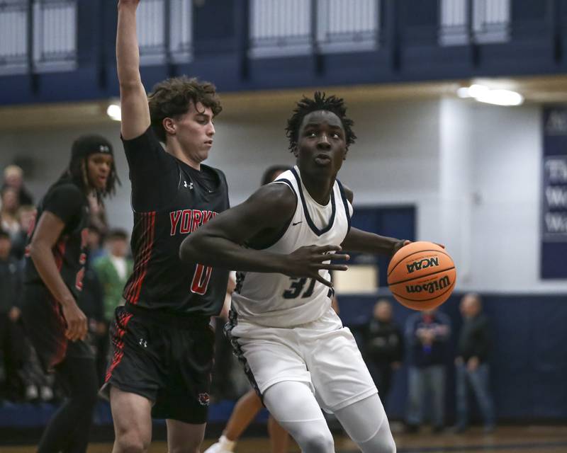Oswego East's Joshua Ankumah-Saikoom (31) makes a move in the post during their basketball game between Yorkville at Oswego East. Friday, Dec 19, 2025 in Oswego.
