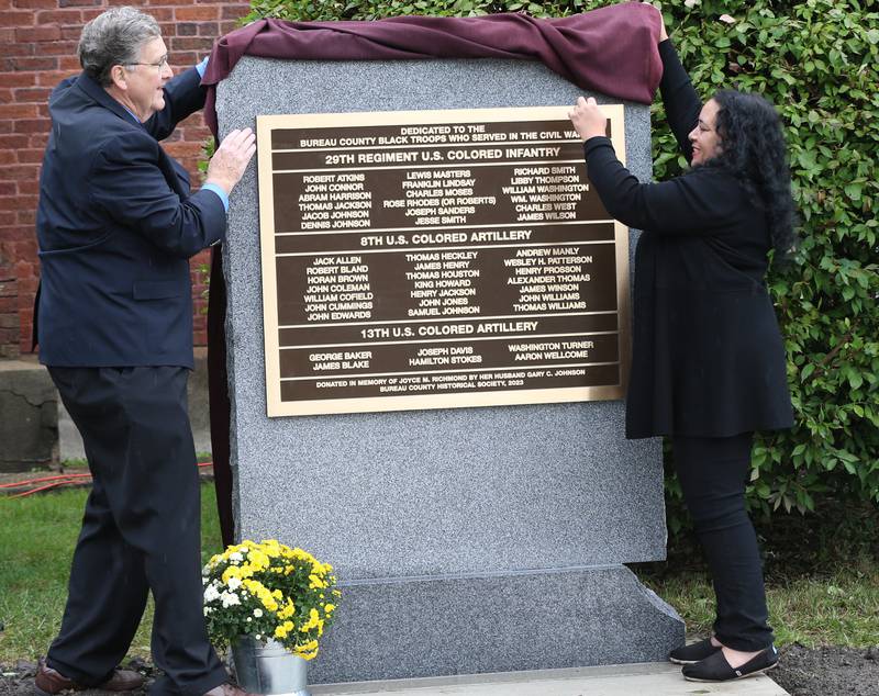 Jim Dunn, Bureau County Historical Society board president and Francis Clarke, a great-grandaughter of Charles Moses Sr unveil a monment during a Civil War Monument Ceremony on Friday, Sept. 22, 2023 outside the Sash Stalter Matson Building in Princeton. The memorial honors 45 black troops who lived in Bureau County and fought in the Civil War.