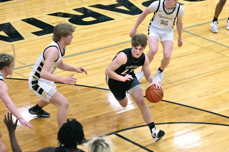 Kaneland's Johnny Spallasso drives between two Sycamore defenders during their game Friday, Feb. 10, 2023, at Sycamore High School.