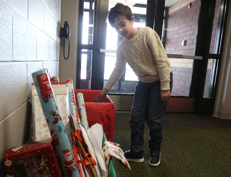 Bini Purelku, a third-grader at Dimmick School places a un-wrapped gift into a box during the Small School Big Hearts campaign on Tuesday, Dec. 2, 2025 at Dimmick School in La Salle. The “Small School, Big Hearts” campaign is a toy drive organizded by third graders and celebrates the power of kindness, generosity and community spirit. Gifts will be wrapped and sent to Officer Santa with the La Salle Police Department and St. Jude. The school is accepting donations through Dec. 12.