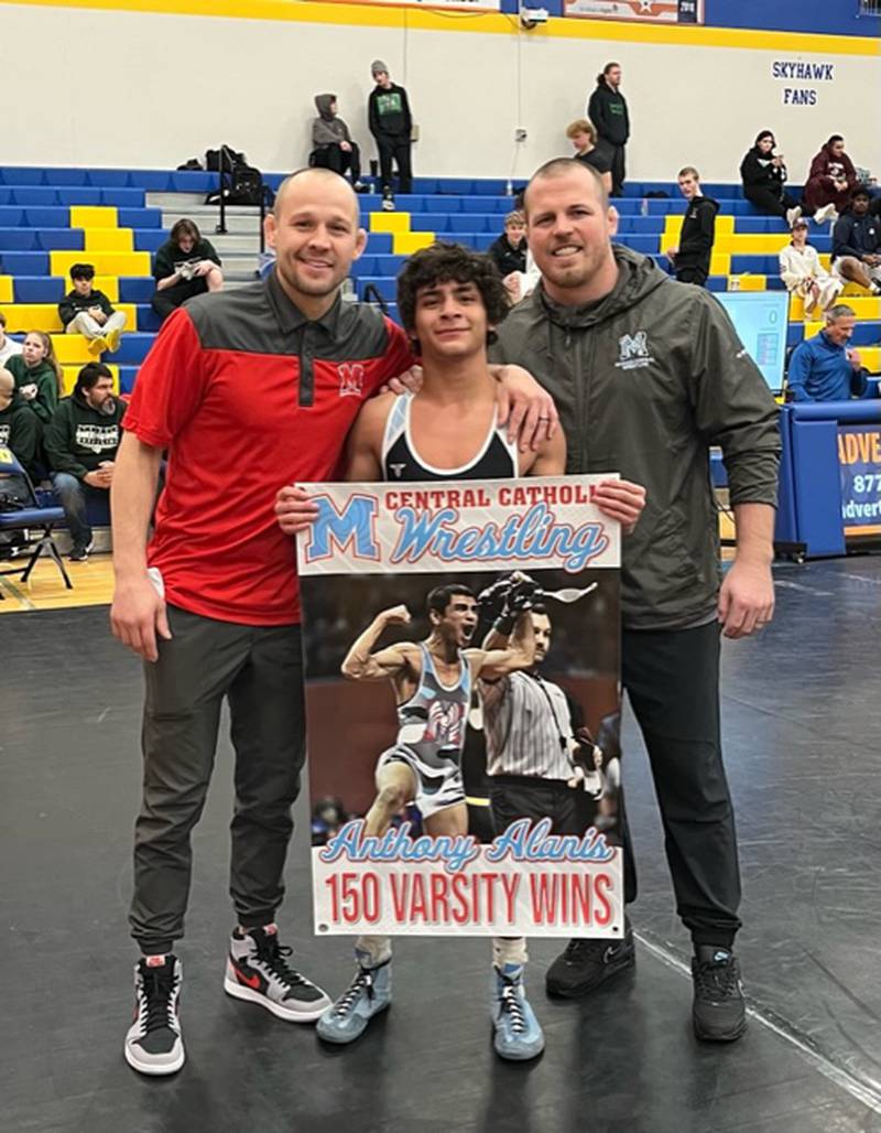 Marian Central senior Anthony Alanis, with Hurricanes co-coaches Ryan Prater (left) and Jordan Blanton (right), after picking up his 150th career win in the Class 1A Johnsburg Wrestling Regional 1130-pound championship.