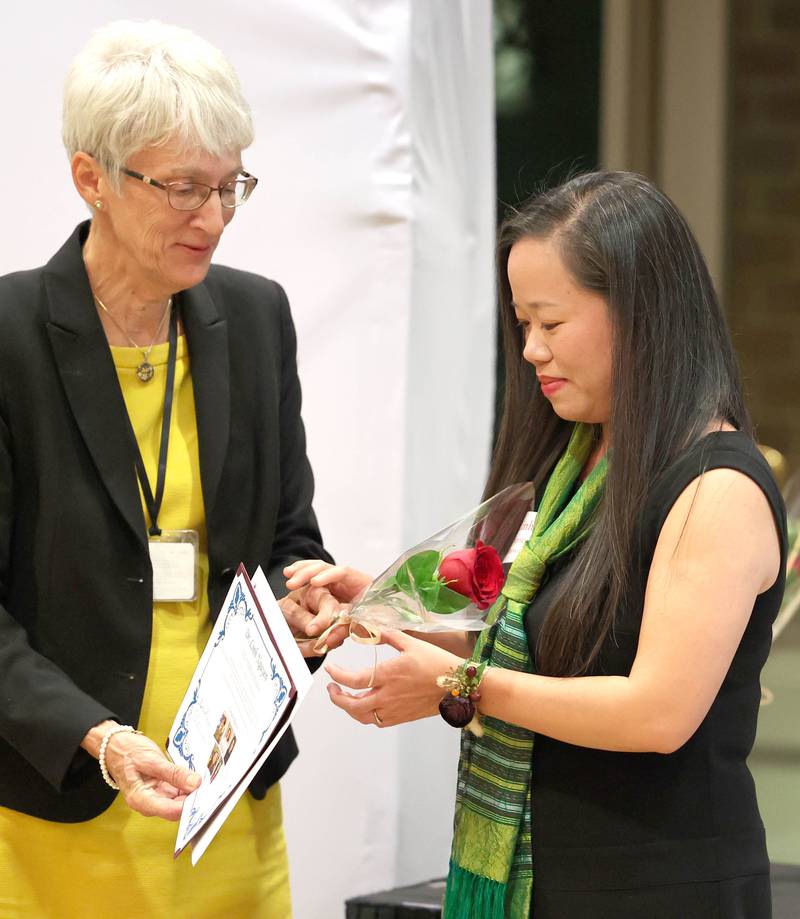 Athena Award finalist Linh Nguyen (right) receives her gifts while being honored Tuesday, Oct. 18, 2022, during the Athena and Women of Accomplishment Award reception at the Barsema Alumni and Visitors Center at Northern Illinois University in DeKalb.