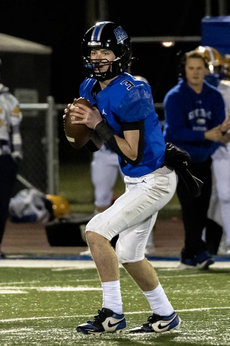 Lincoln-Way East's Evan LeFevour looks for an open teammate during a varsity football game against Sandburg at Lincoln-Way East on Oct. 23, 2025.