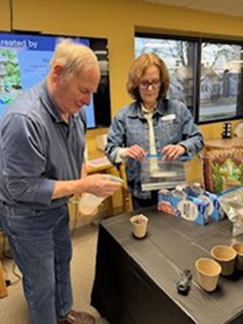 Cathy Flynn assists a participant in the University of Illinois Extension's Master Gardener Program at Oglesby Library on Wednesday, March 26.