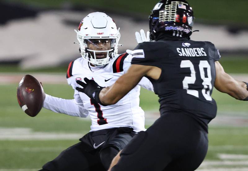 Northern Illinois' Nevaeh Sanders pressures Ball State quarterback Kiael Kelly during their game Tuesday, Nov. 7, 2023, in Huskie Stadium at NIU in DeKalb.